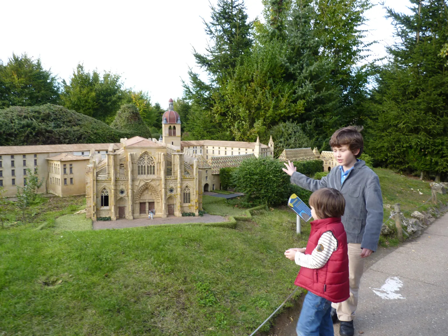 Two boys on a day out in France — big brother teaching little brother about history